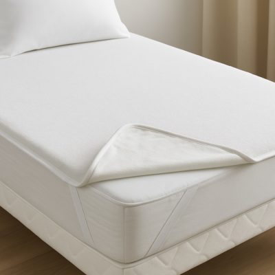 Waterdichte molton op matras met hoek omgeslagen om de beschermlaag te tonen.